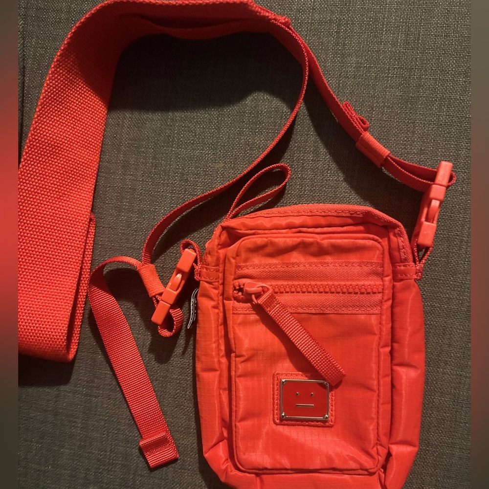 Acne Studios cross body bag, phone pouch in red and unisex, discounted
